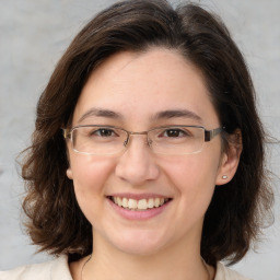 Joyful white adult female with medium  brown hair and brown eyes