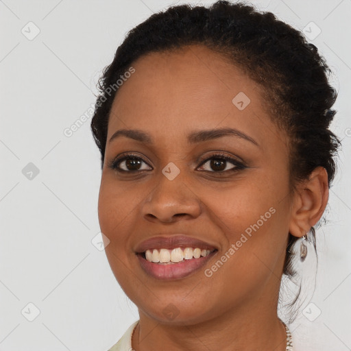 Joyful black young-adult female with short  brown hair and brown eyes