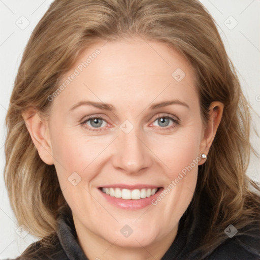 Joyful white adult female with medium  brown hair and blue eyes