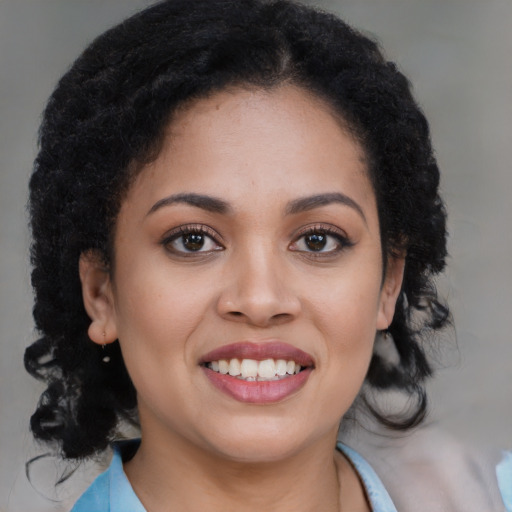 Joyful black young-adult female with long  brown hair and brown eyes