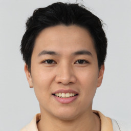 Joyful asian young-adult male with short  black hair and brown eyes