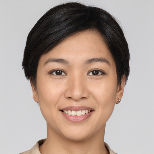Joyful white young-adult female with short  black hair and brown eyes