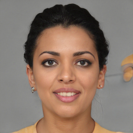 Joyful latino young-adult female with short  black hair and brown eyes