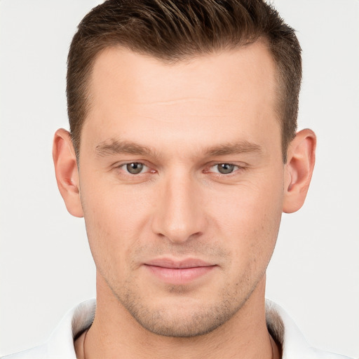 Joyful white young-adult male with short  brown hair and brown eyes