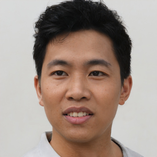 Joyful asian young-adult male with short  black hair and brown eyes