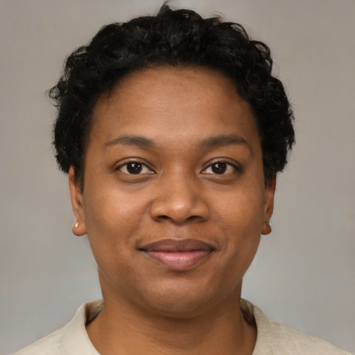 Joyful black young-adult female with short  black hair and brown eyes