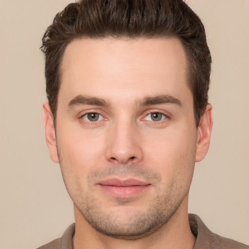 Joyful white young-adult male with short  brown hair and brown eyes