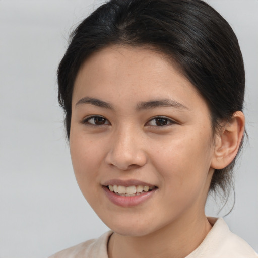 Joyful asian young-adult female with medium  brown hair and brown eyes