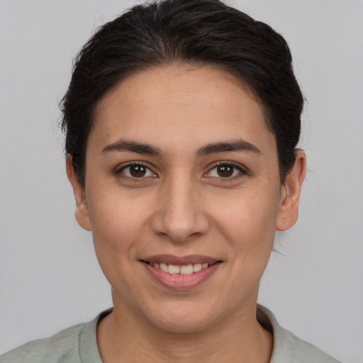 Joyful white young-adult female with short  brown hair and brown eyes