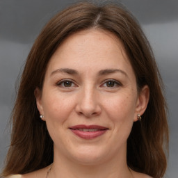 Joyful white adult female with medium  brown hair and brown eyes