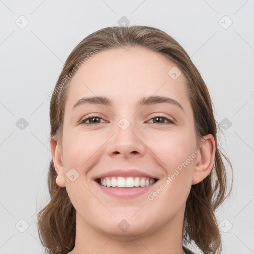 Joyful white young-adult female with medium  brown hair and grey eyes