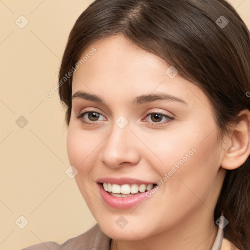 Joyful white young-adult female with medium  brown hair and brown eyes