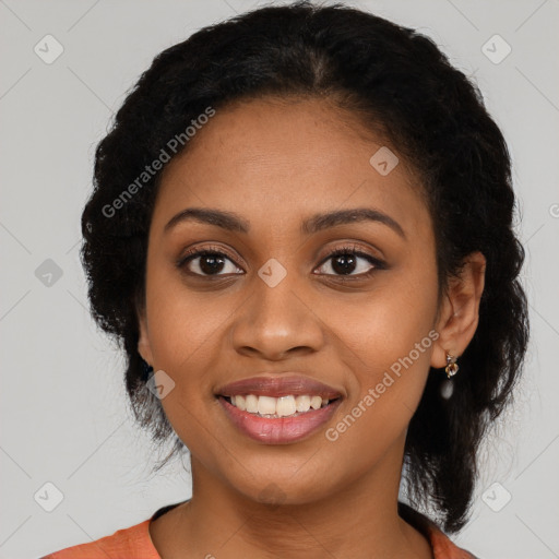 Joyful black young-adult female with long  black hair and brown eyes