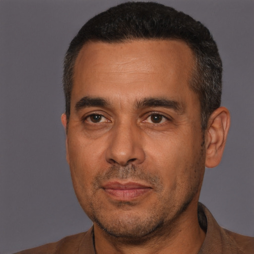Joyful white adult male with short  black hair and brown eyes