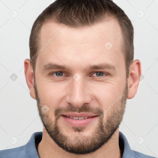 Joyful white young-adult male with short  brown hair and grey eyes