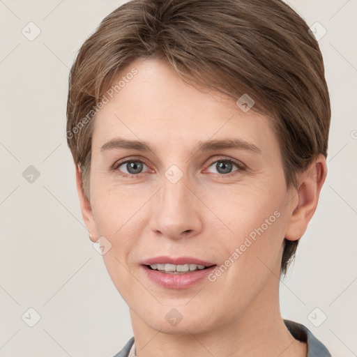 Joyful white young-adult female with short  brown hair and grey eyes