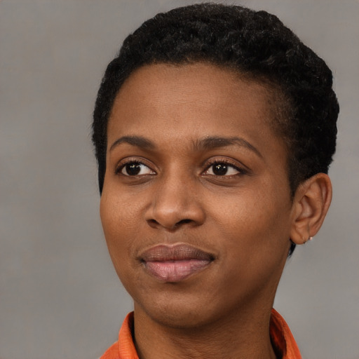 Joyful black young-adult female with short  black hair and brown eyes