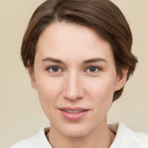 Joyful white young-adult female with short  brown hair and brown eyes