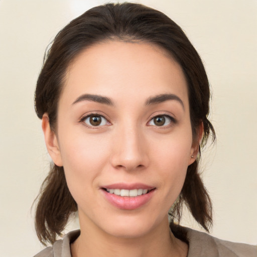 Joyful white young-adult female with medium  brown hair and brown eyes