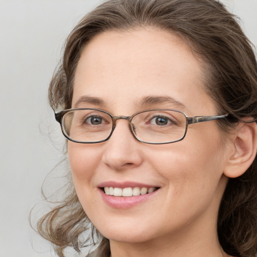 Joyful white young-adult female with medium  brown hair and blue eyes