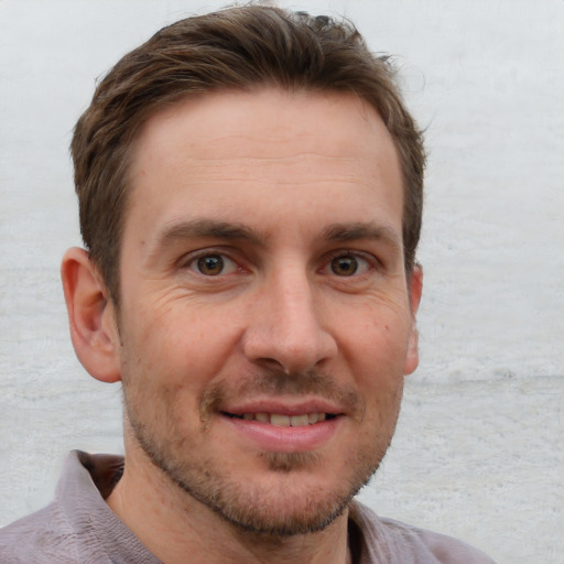 Joyful white adult male with short  brown hair and grey eyes