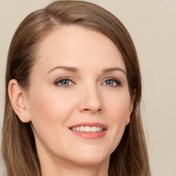 Joyful white young-adult female with long  brown hair and blue eyes