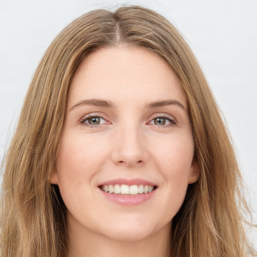 Joyful white young-adult female with long  brown hair and green eyes