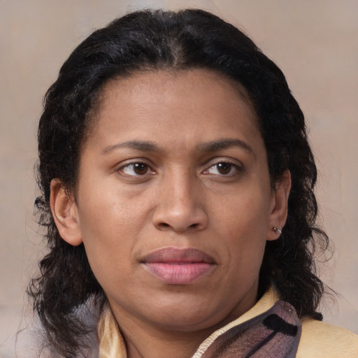 Joyful latino adult female with medium  brown hair and brown eyes