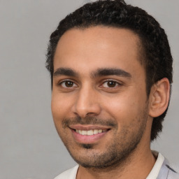 Joyful latino young-adult male with short  black hair and brown eyes