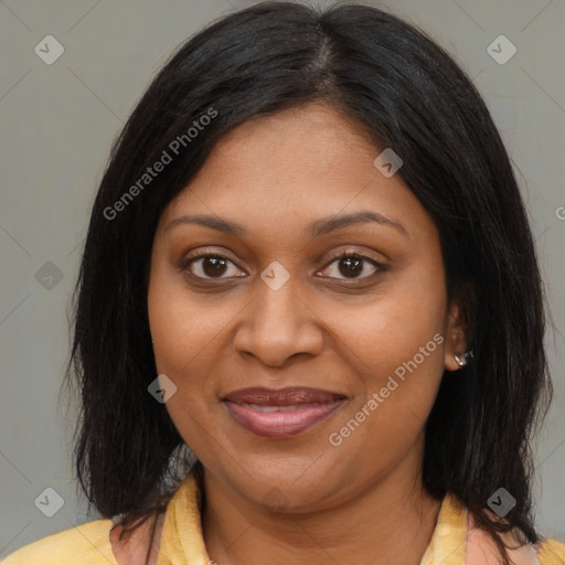 Joyful black adult female with long  brown hair and brown eyes