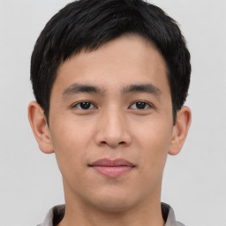 Joyful asian young-adult male with short  black hair and brown eyes