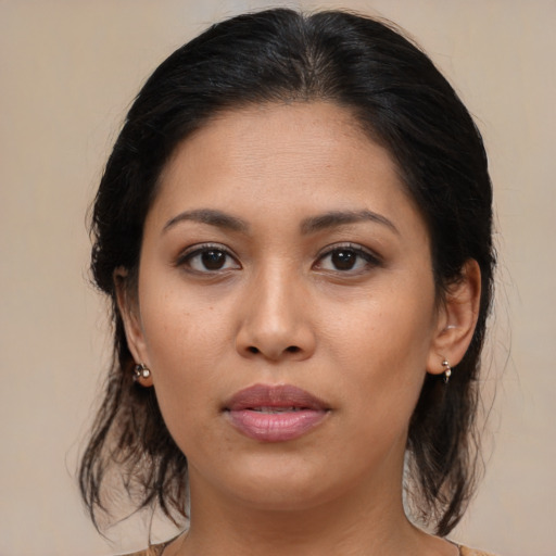 Joyful latino young-adult female with medium  brown hair and brown eyes