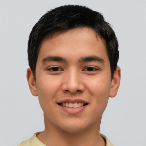 Joyful asian young-adult male with short  brown hair and brown eyes