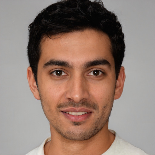 Joyful white young-adult male with short  black hair and brown eyes