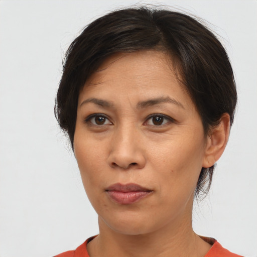 Neutral asian adult female with short  brown hair and brown eyes