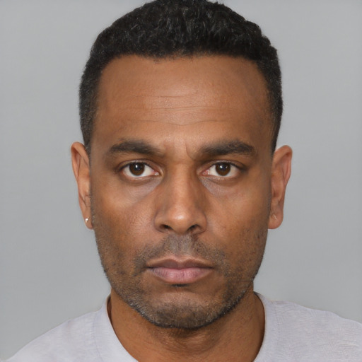 Neutral black adult male with short  black hair and brown eyes