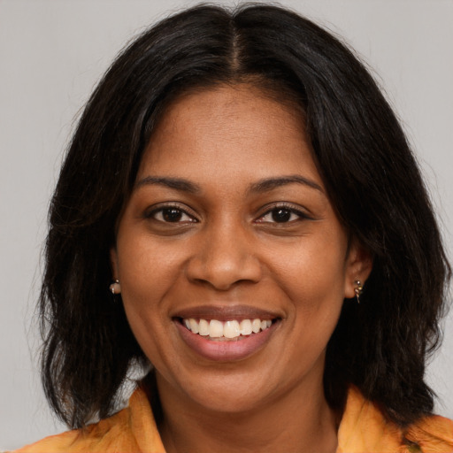 Joyful black young-adult female with medium  brown hair and brown eyes