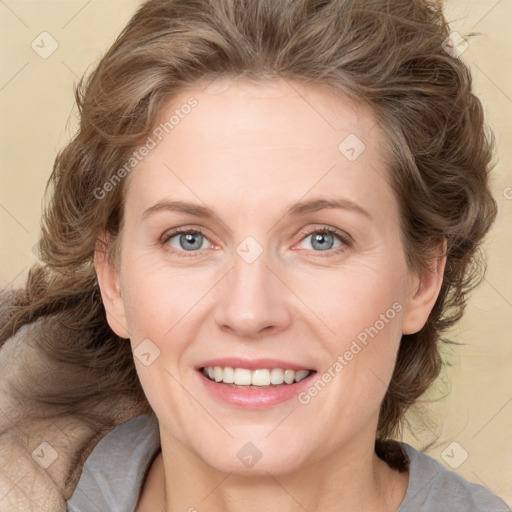 Joyful white adult female with medium  brown hair and blue eyes