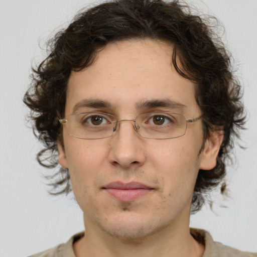 Joyful white adult male with medium  brown hair and green eyes