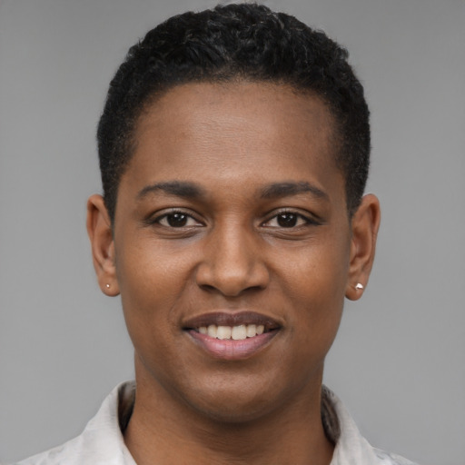 Joyful black young-adult male with short  brown hair and brown eyes