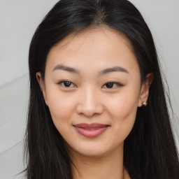 Joyful asian young-adult female with long  brown hair and brown eyes