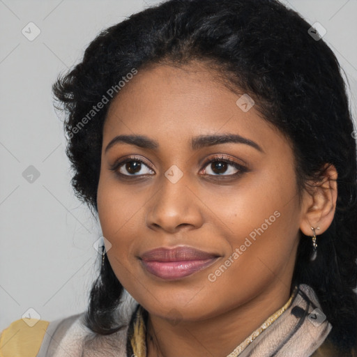 Joyful black young-adult female with long  black hair and brown eyes