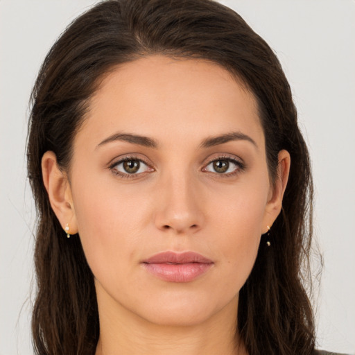 Joyful white young-adult female with long  brown hair and brown eyes