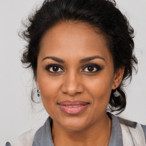 Joyful black young-adult female with medium  brown hair and brown eyes