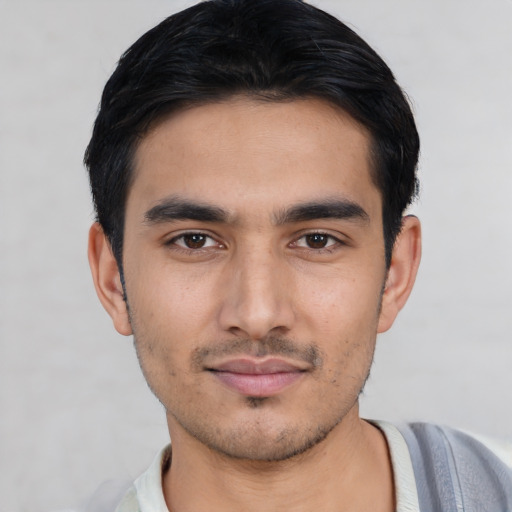 Joyful asian young-adult male with short  black hair and brown eyes