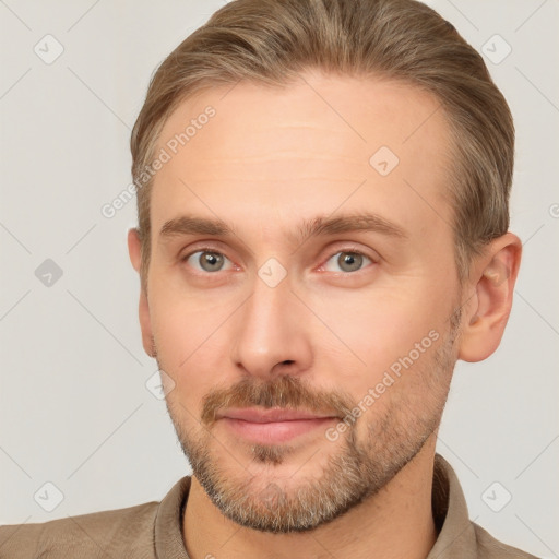 Joyful white adult male with short  brown hair and grey eyes