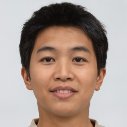 Joyful asian young-adult male with short  brown hair and brown eyes