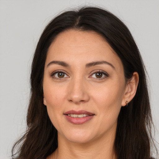 Joyful white young-adult female with long  brown hair and brown eyes