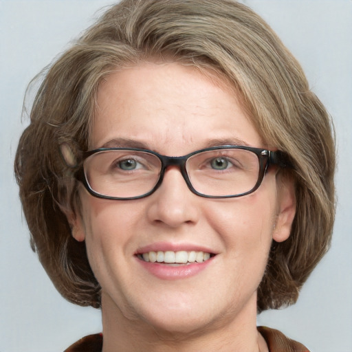 Joyful white adult female with medium  brown hair and blue eyes