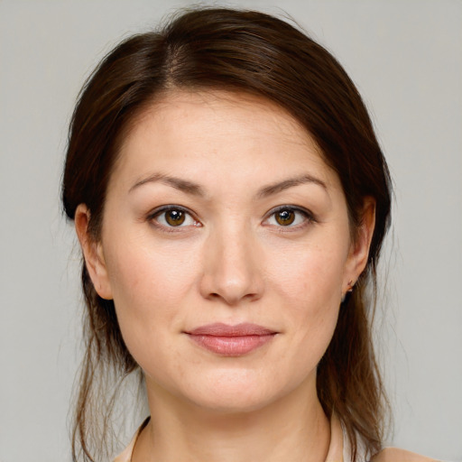 Joyful white young-adult female with medium  brown hair and grey eyes